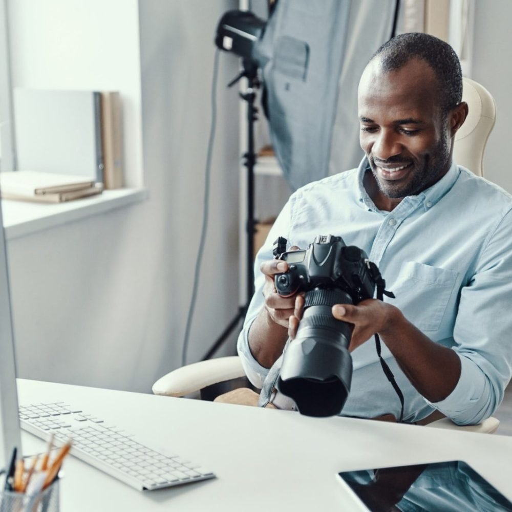 handsome-young-african-man-holding-digital-camera-2023-11-27-05-04-59-utc-scaled-1.jpg
