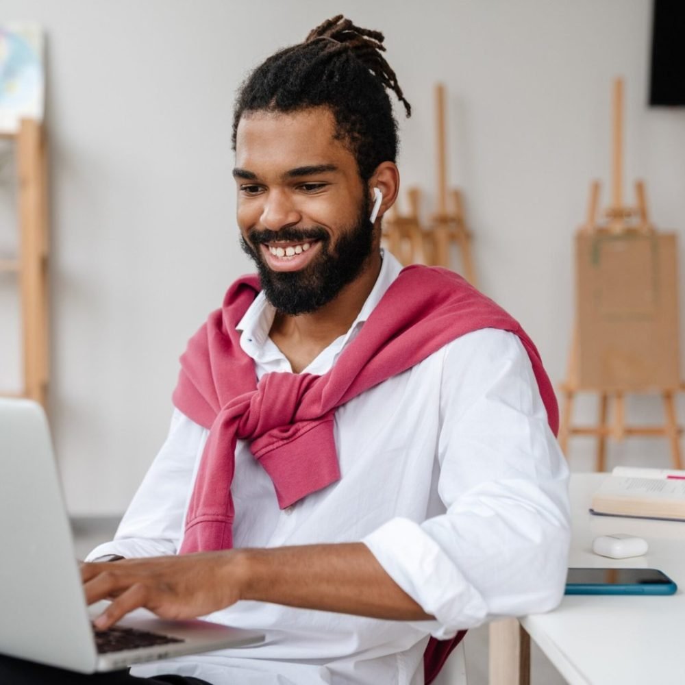 happy-african-american-guy-in-earphones-working-wi-2023-11-27-05-36-23-scaled-1.jpg