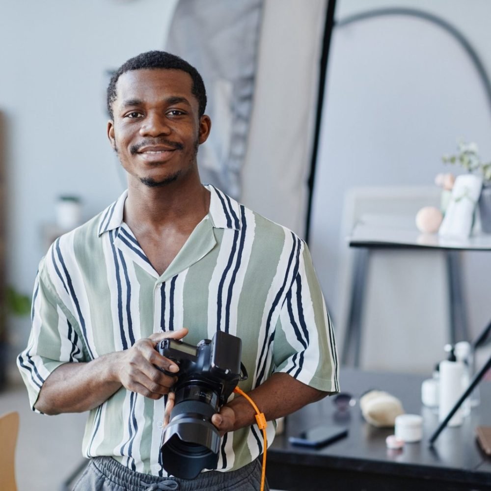portrait-of-black-young-man-with-photo-camera-2023-11-27-04-59-24-utc-scaled-1.jpg